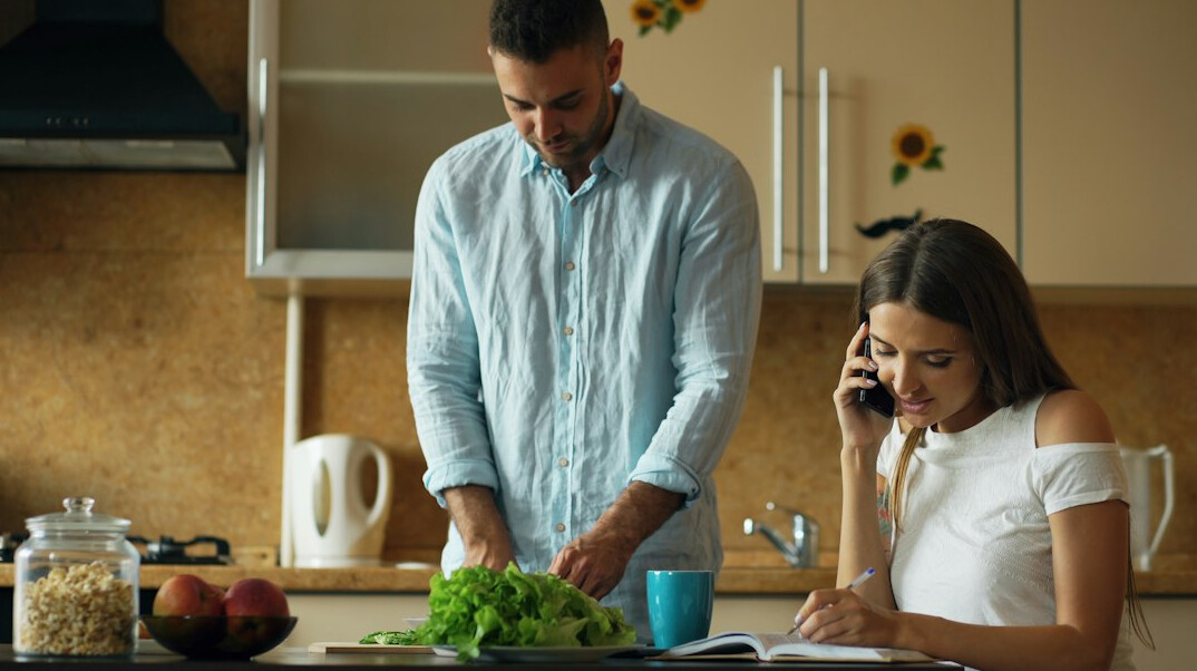 Mexican couple planning their household budget at home with a laptop